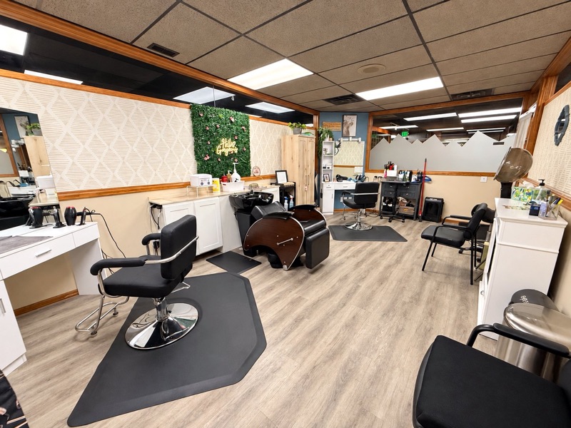 One of the booth rooms at Springs Spa & Salon in Colorado Springs, with styling stations and a shampoo bowl